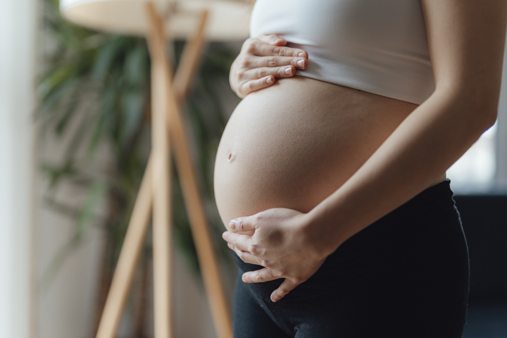 Pregnant woman holding belly