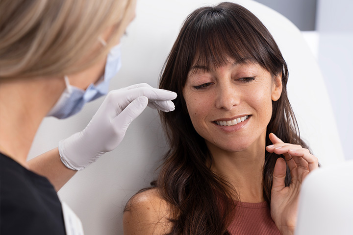 A medical professional discussing Botox or Xeomin treatments with a patient.